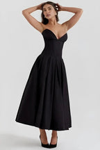 Back view of the Laarni yellow strapless corset midi dress showing the zipper and pleated skirt.